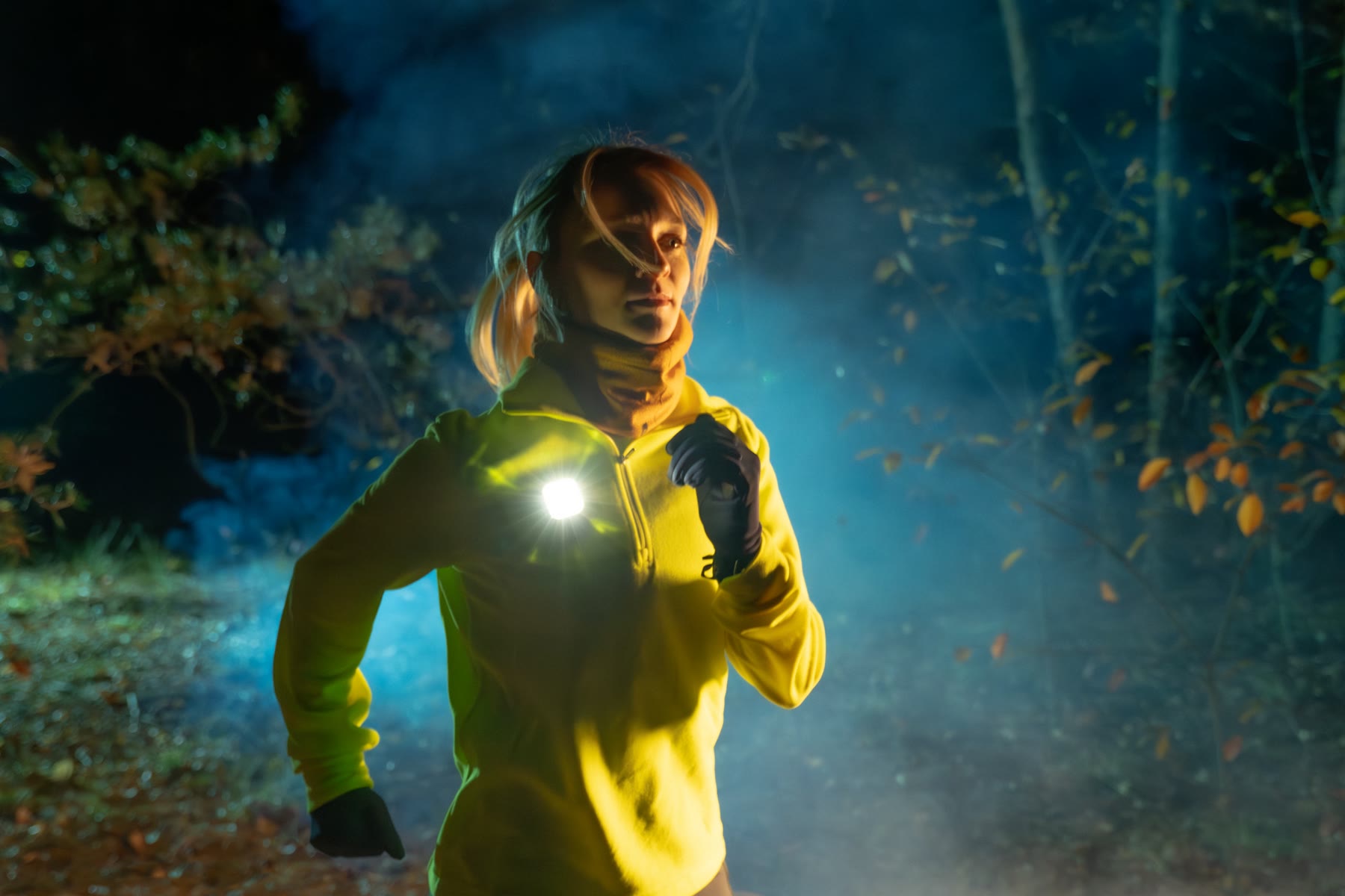 Trail runner lit by a LightPlus wearable light at night