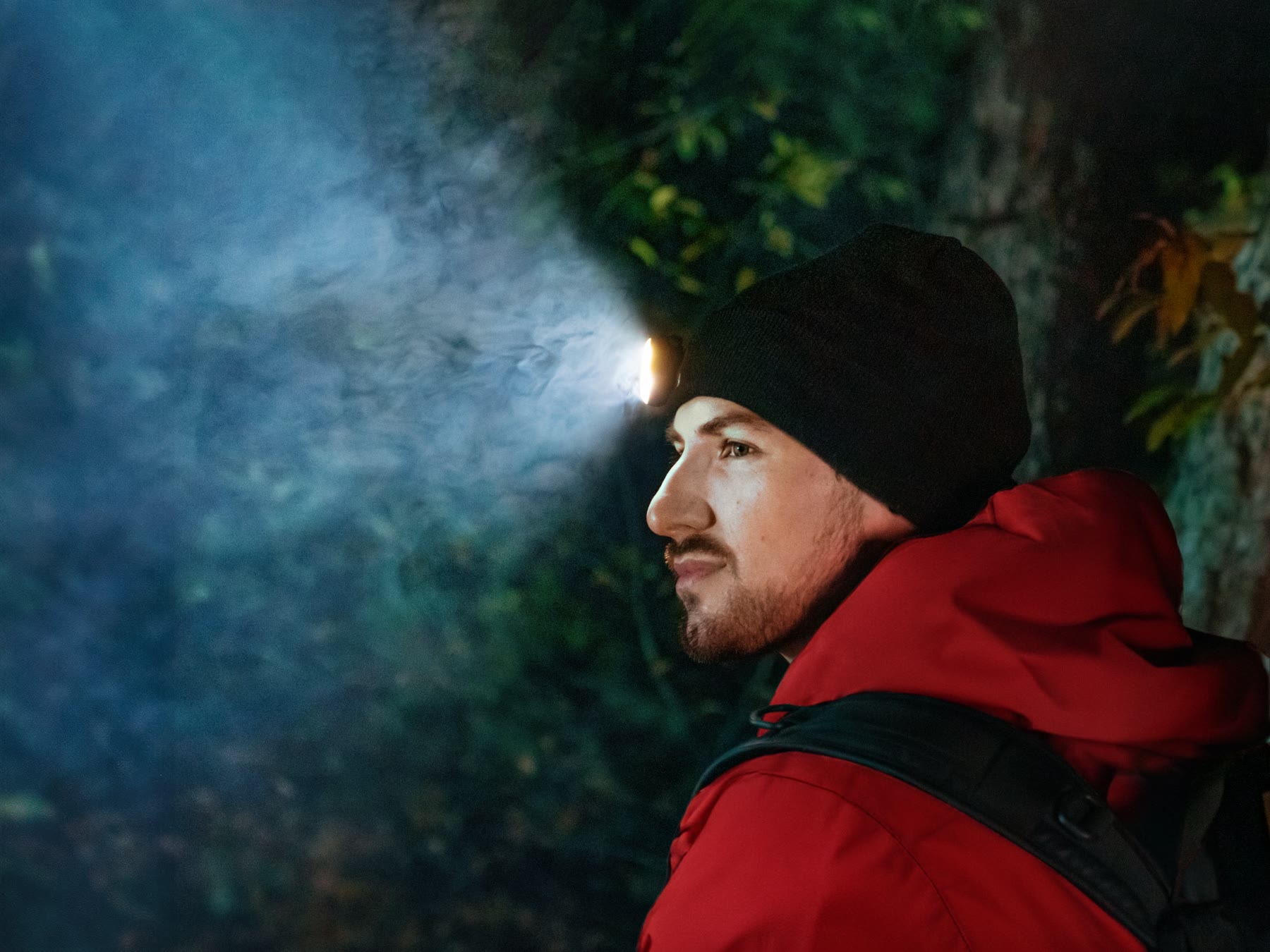 Hiker with a bright LightPlus headlamp beam in the dark